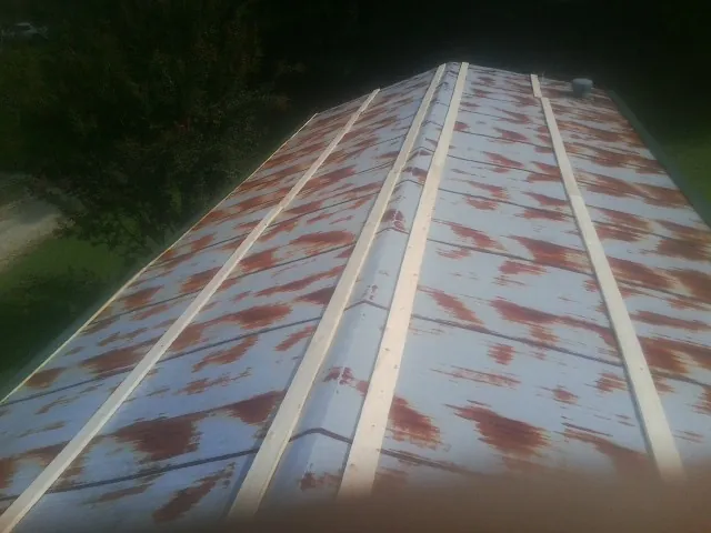 Rusted metal roof panels with new wood purlins before replacement — Storm Damage Roof Repair in Sumpter by Roofing Brothers