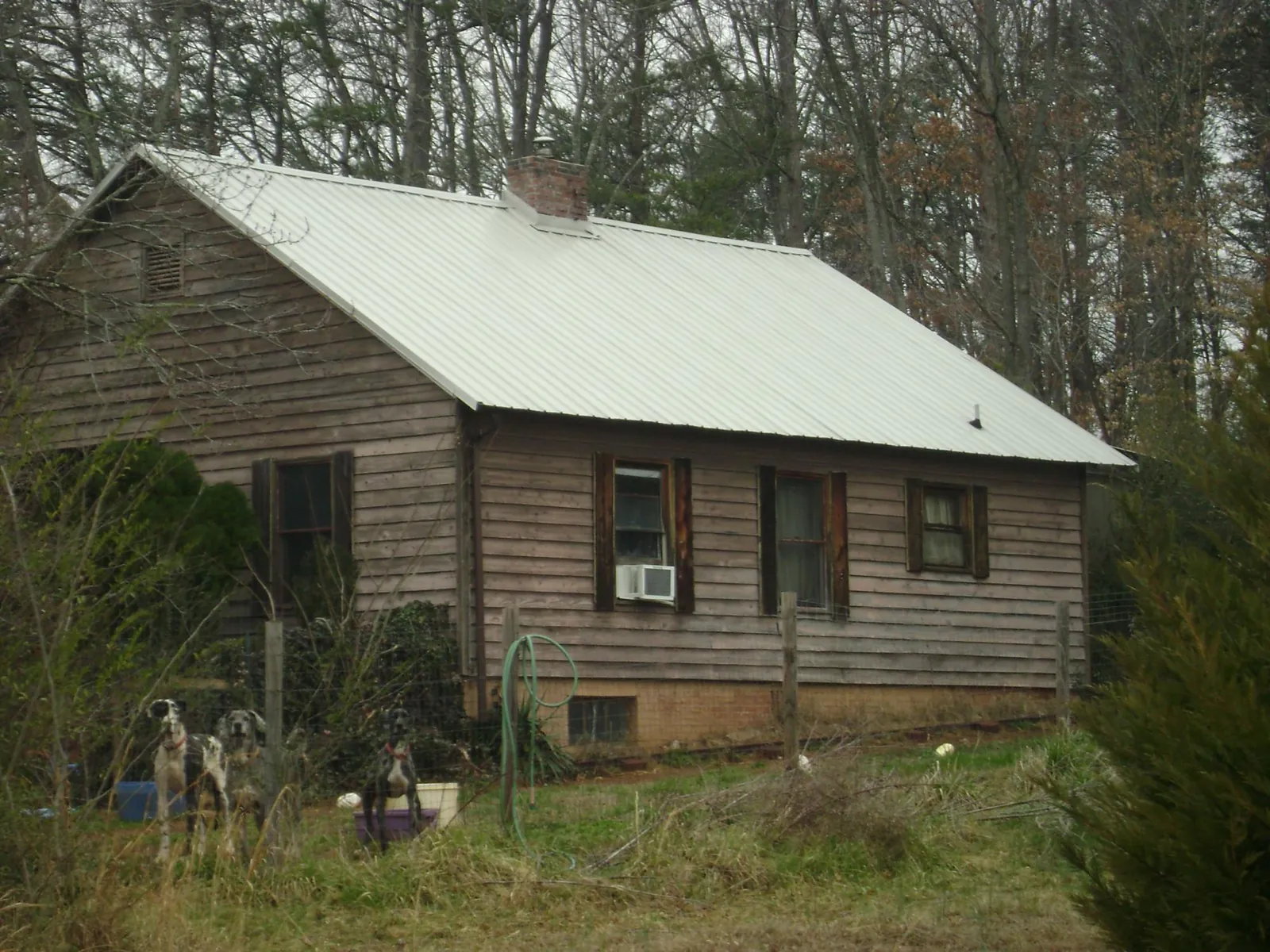 White metal roof on an old wood sided farmhouse, from a Metal Roof Installation job in Sumpter
